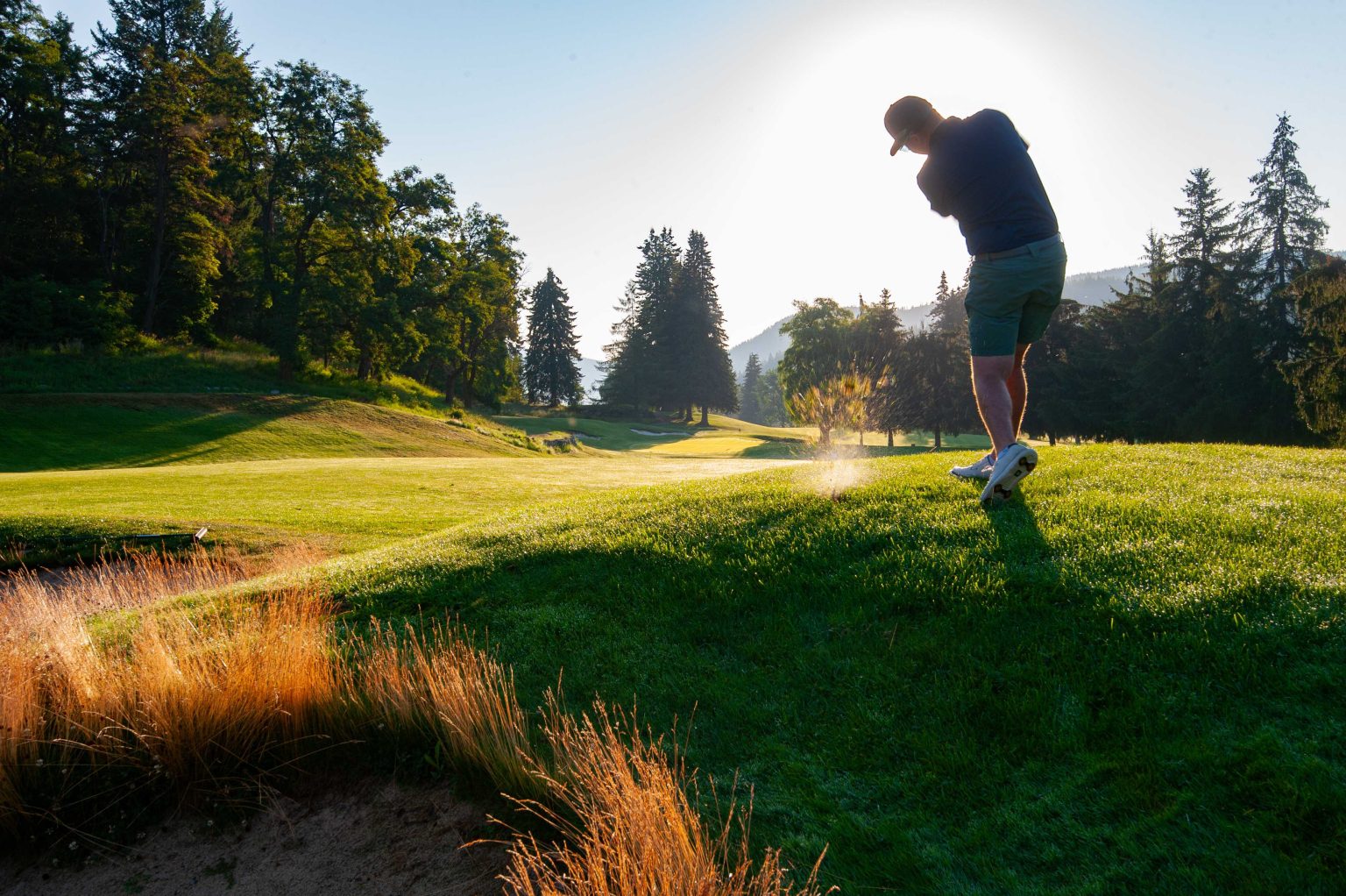 Golfer Swinging at Hole 1