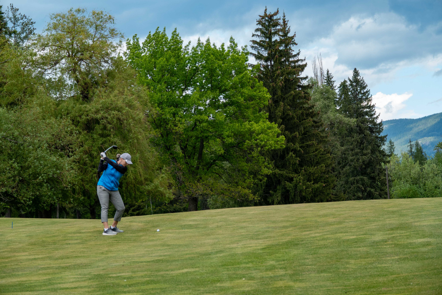 Hole6May2026-2 Golfer executing a smooth swing in the Kootenay Mountains