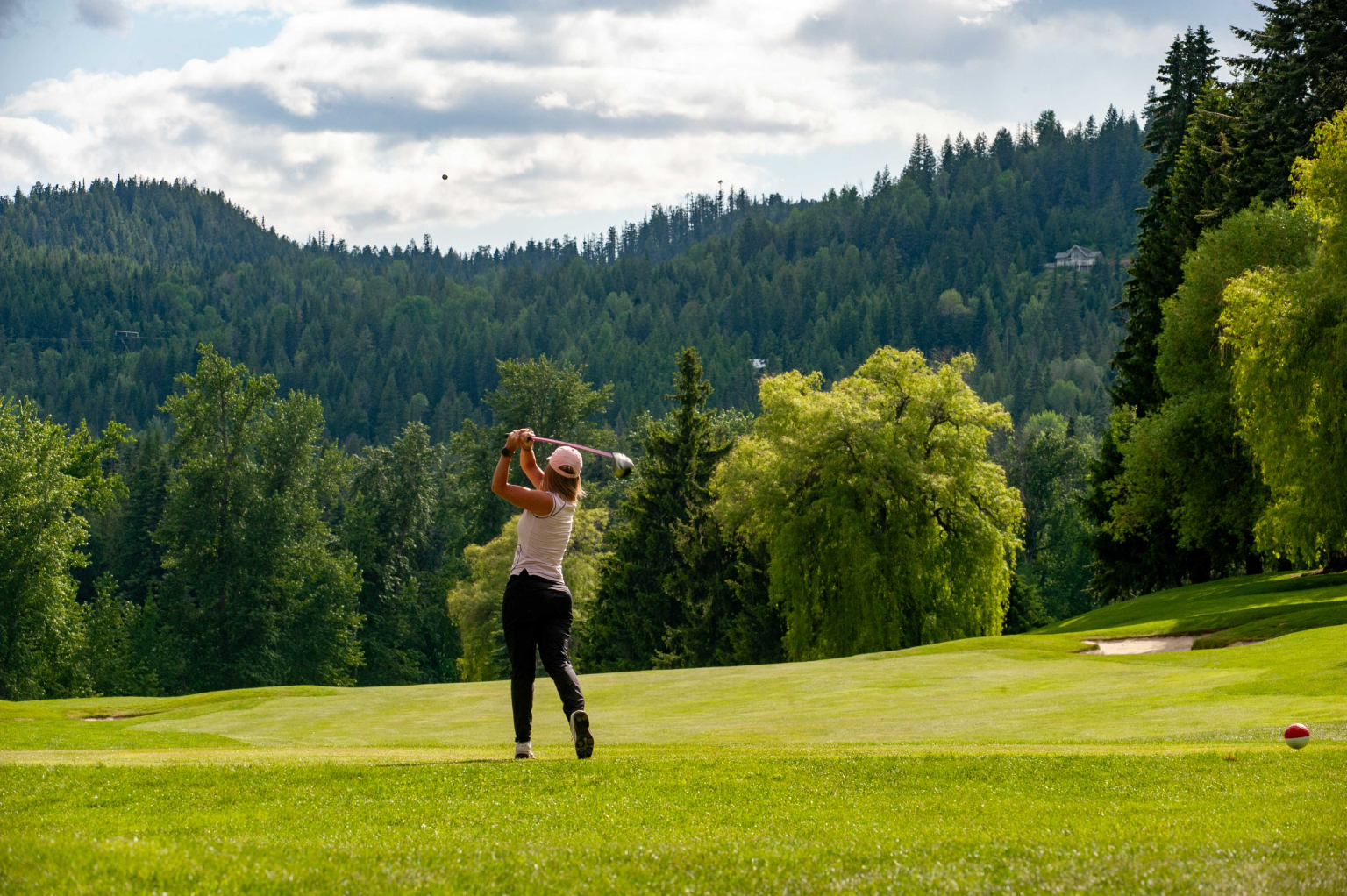 Golfer practicing their swing in Rossland BC